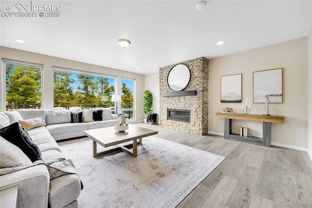 living area featuring a fireplace, baseboards, hardwood / wood-style floors, and recessed lighting