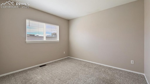 unfurnished room featuring visible vents, baseboards, and carpet