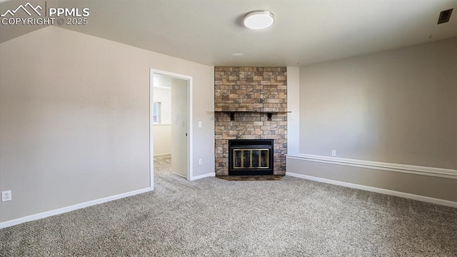 unfurnished living room with carpet, a fireplace, and baseboards