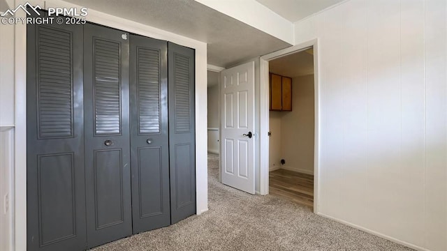 hall featuring light colored carpet