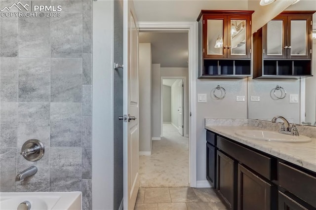 bathroom with vanity, tile patterned floors, baseboards, and shower / bath combination