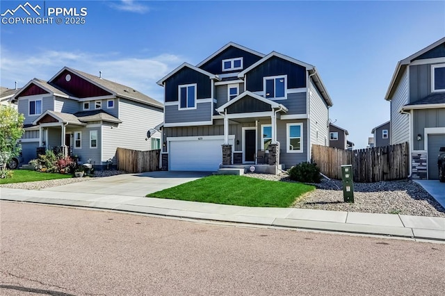 craftsman-style home featuring a garage, board and batten siding, driveway, and fence