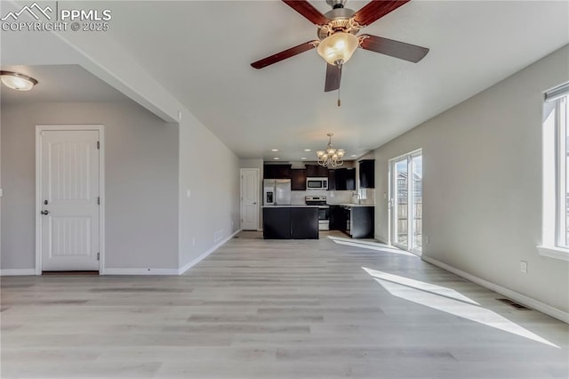 kitchen with visible vents, open floor plan, a center island, stainless steel appliances, and light countertops