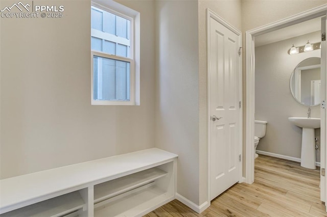 mudroom with light wood-type flooring and baseboards