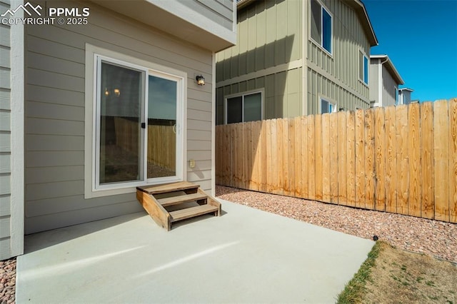 view of patio featuring entry steps and fence