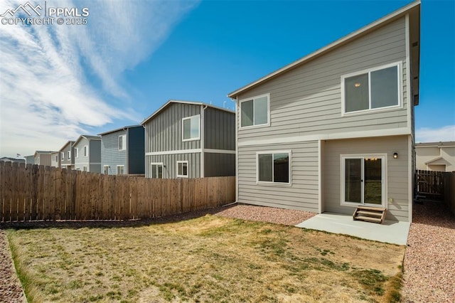 rear view of house with a yard, entry steps, a patio area, a residential view, and a fenced backyard