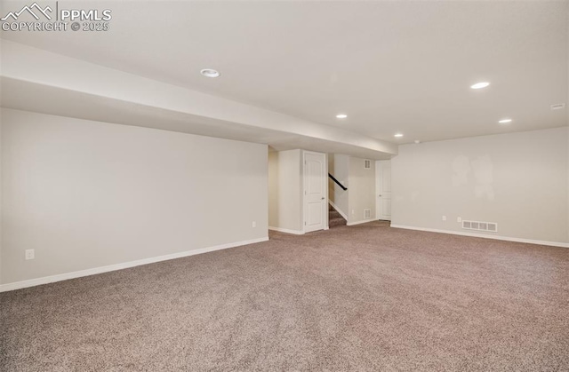 finished basement featuring carpet, stairs, baseboards, and recessed lighting