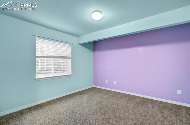 unfurnished room with carpet floors and baseboards