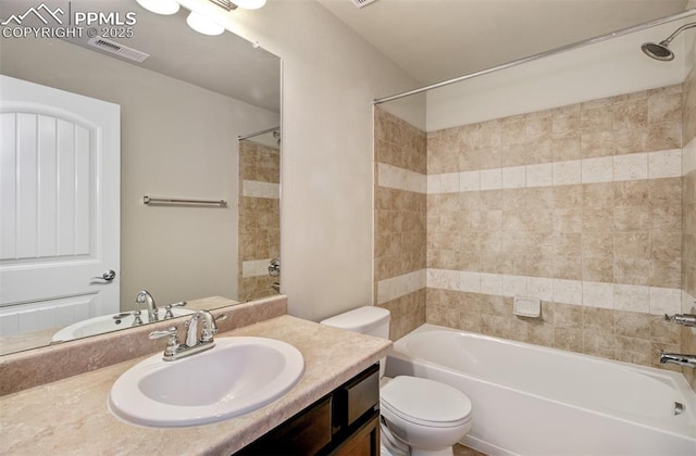 bathroom with shower / washtub combination, visible vents, vanity, and toilet