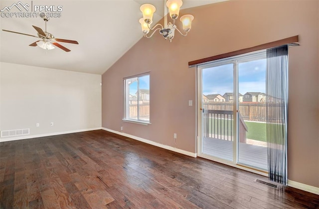 spare room featuring lofted ceiling, baseboards, visible vents, and wood finished floors