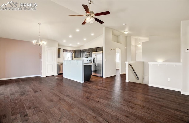 kitchen featuring lofted ceiling, a kitchen island, appliances with stainless steel finishes, open floor plan, and light countertops