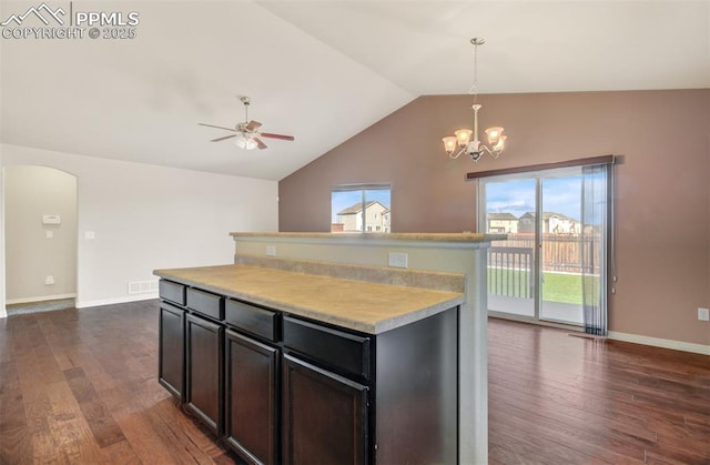 kitchen with arched walkways, dark wood finished floors, visible vents, and lofted ceiling