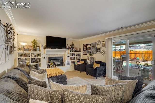 carpeted living area featuring a glass covered fireplace, visible vents, and crown molding