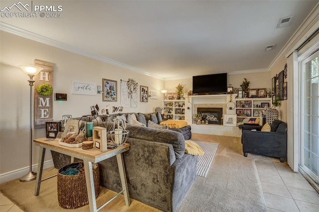 living room with a fireplace with raised hearth, ornamental molding, light tile patterned flooring, and visible vents