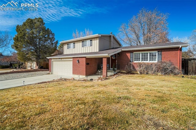 traditional-style home featuring driveway, brick siding, fence, board and batten siding, and a front yard