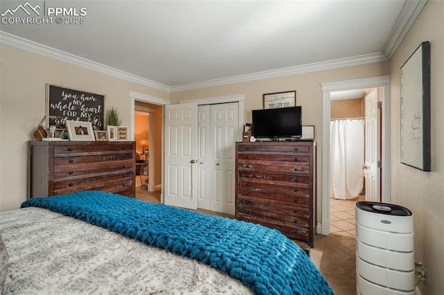 bedroom with ornamental molding, a closet, and carpet floors