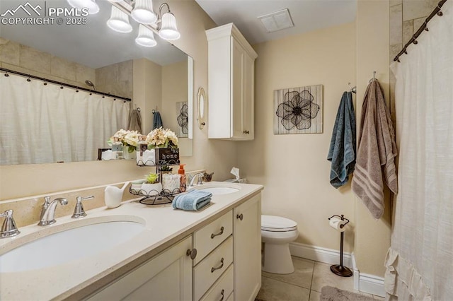 bathroom with toilet, tile patterned flooring, a sink, and visible vents