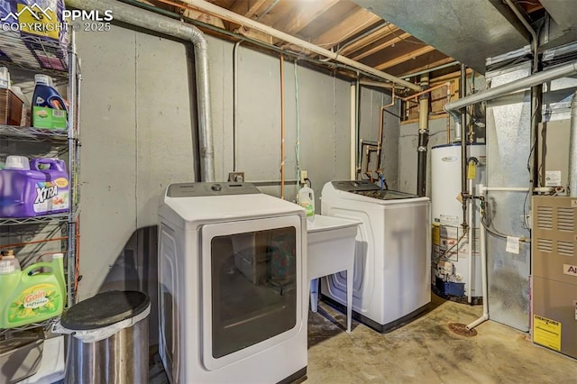 clothes washing area featuring laundry area, gas water heater, heating unit, and separate washer and dryer