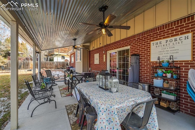 view of patio with ceiling fan, fence, and outdoor dining space