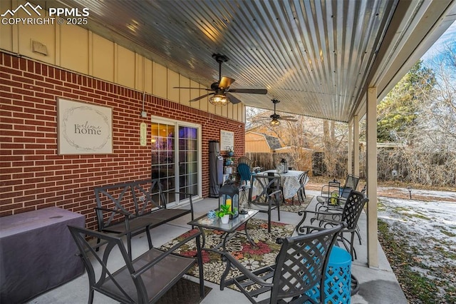 view of patio with outdoor dining area and a ceiling fan