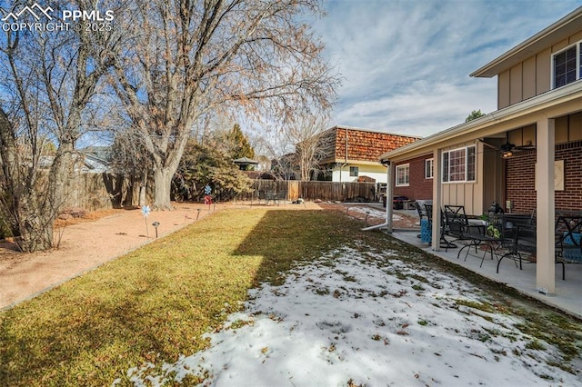 view of yard featuring a fenced backyard, ceiling fan, and a patio