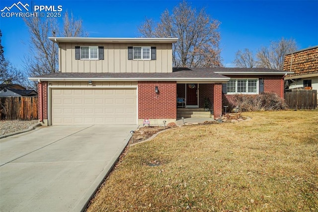 split level home with a front yard, fence, and brick siding