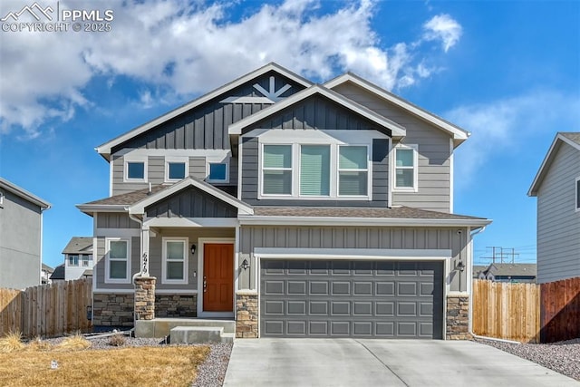 craftsman-style home with concrete driveway, board and batten siding, fence, a garage, and stone siding