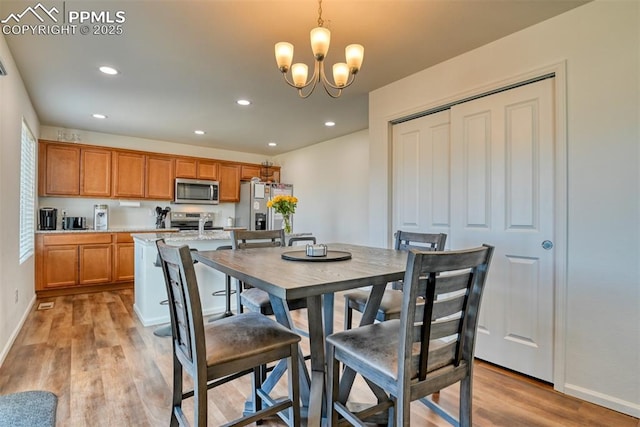 dining space featuring light wood-type flooring, baseboards, a chandelier, and recessed lighting