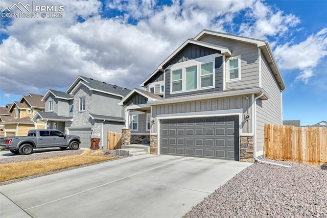 craftsman house with board and batten siding, fence, a garage, a residential view, and driveway