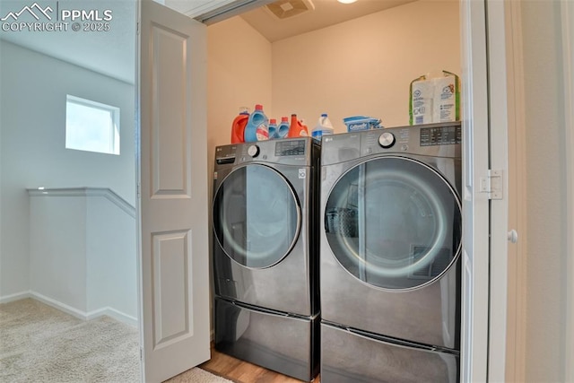 laundry room featuring laundry area, visible vents, baseboards, carpet flooring, and separate washer and dryer