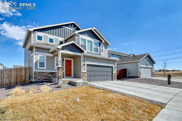 craftsman-style house with a garage, fence, stone siding, concrete driveway, and board and batten siding