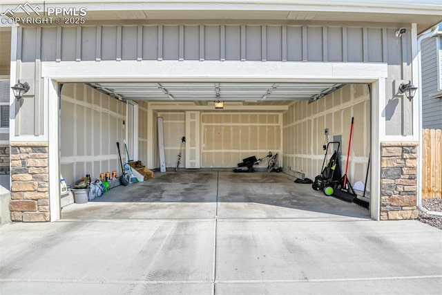 garage featuring a garage door opener and driveway