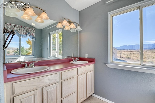 bathroom featuring double vanity, tile patterned flooring, a sink, and a mountain view