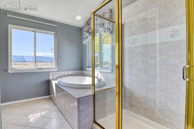 bathroom featuring baseboards, a garden tub, tile patterned flooring, a shower stall, and a mountain view