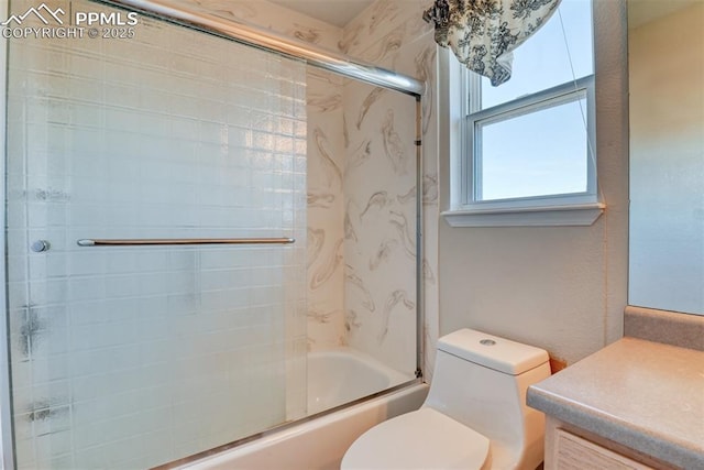 full bath featuring vanity, toilet, and bath / shower combo with glass door