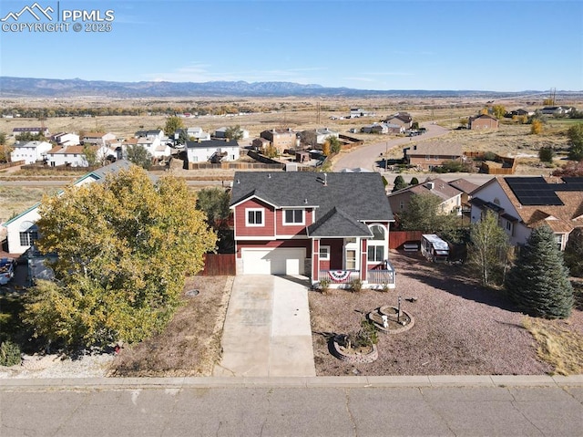 drone / aerial view featuring a residential view and a mountain view