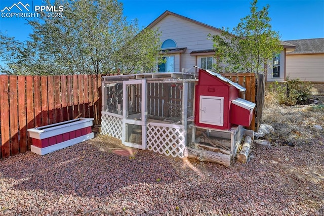 view of poultry coop featuring fence