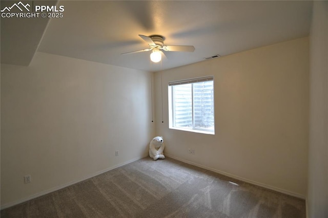 carpeted empty room with visible vents, ceiling fan, and baseboards