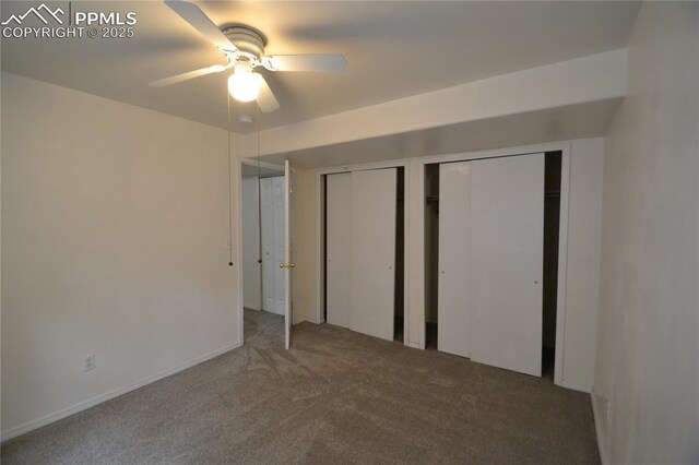 unfurnished bedroom featuring ceiling fan, carpet floors, and multiple closets