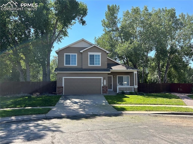 view of front of property featuring a front yard, fence, driveway, and an attached garage