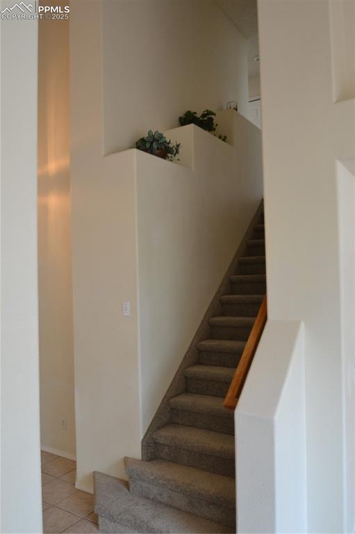 stairs with tile patterned floors