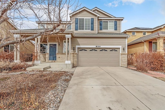 craftsman house with an attached garage, concrete driveway, and brick siding