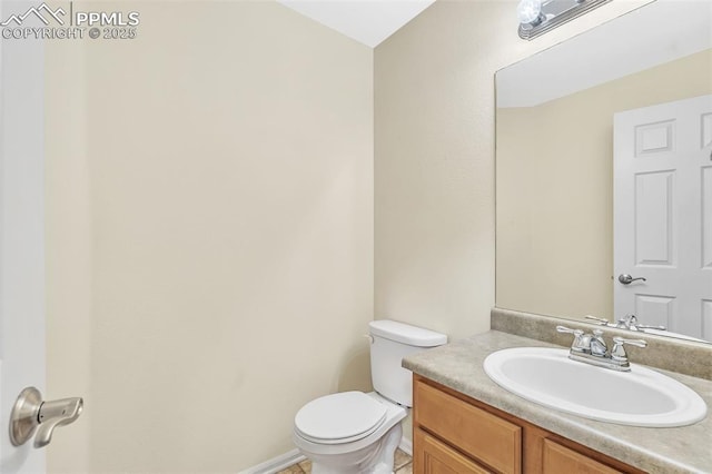 half bathroom with vanity and toilet