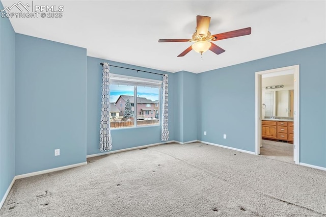 unfurnished bedroom featuring carpet floors, ceiling fan, baseboards, and connected bathroom