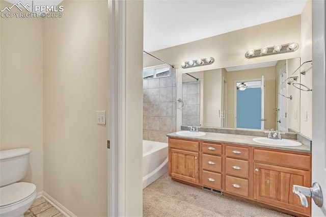 full bathroom with visible vents, double vanity, a sink, and toilet