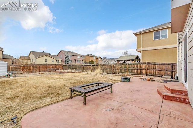 view of patio / terrace featuring a fenced backyard and a residential view