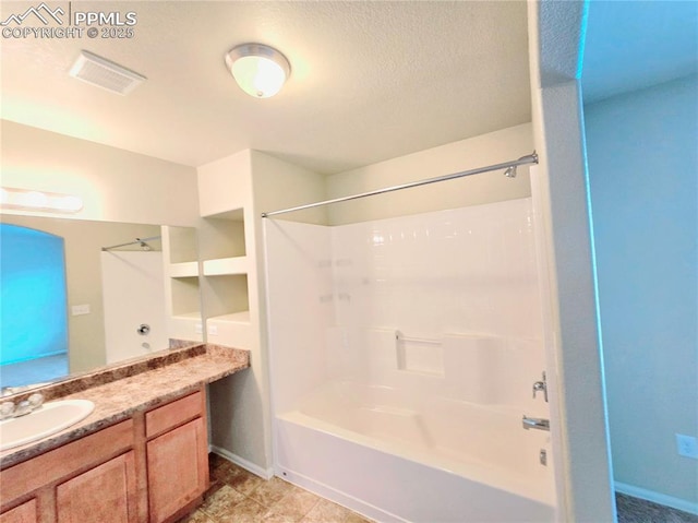 bathroom featuring visible vents, baseboards, vanity, shower / bathtub combination, and a textured ceiling