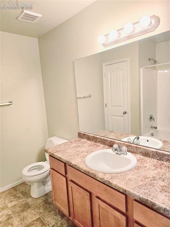 full bath with vanity, toilet, visible vents, and shower / bath combination