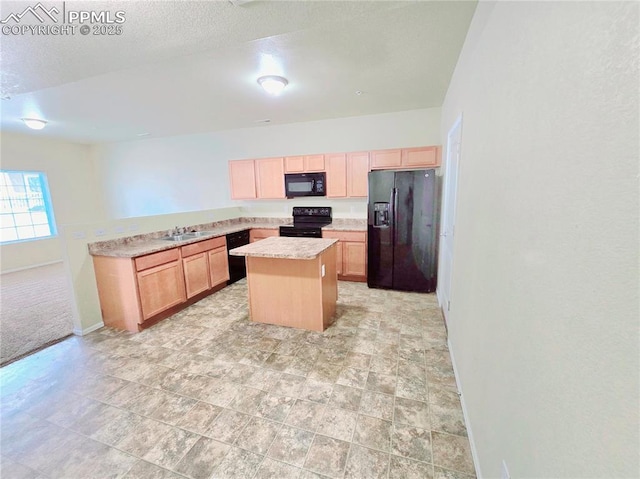 kitchen featuring black appliances, light brown cabinets, a center island, a peninsula, and light countertops