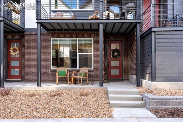 property entrance with brick siding